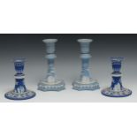 A pair of 19th century Wedgwood Jasperware candlesticks, typically sprigged with classical