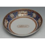 An 18th century Chinese saucer dish, the field with initials in a canted cartouche, the rim banded