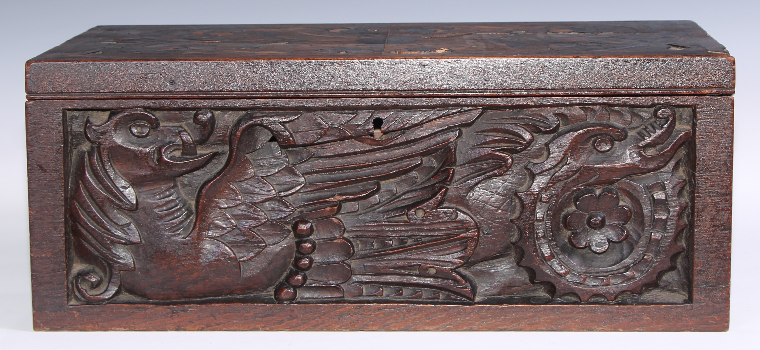 A large 19th century oak writing box, incorporating earlier panels, hinged cover inlaid in holly and