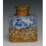 A Dutch Delft canted rectangular tea caddy, painted in tones of blue with figures and landscape