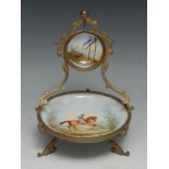 A French gilt metal and porcelain pocket watch stand, decorated in polychrome with a racehorse, 17cm