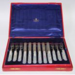 An Edwardian silver and mother of pearl dessert service, comprising twelve pairs of fruit knives and