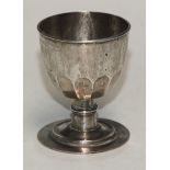 An 18th century half-fluted chalice, ring-knop to stem, stepped circular foot, 8cm high