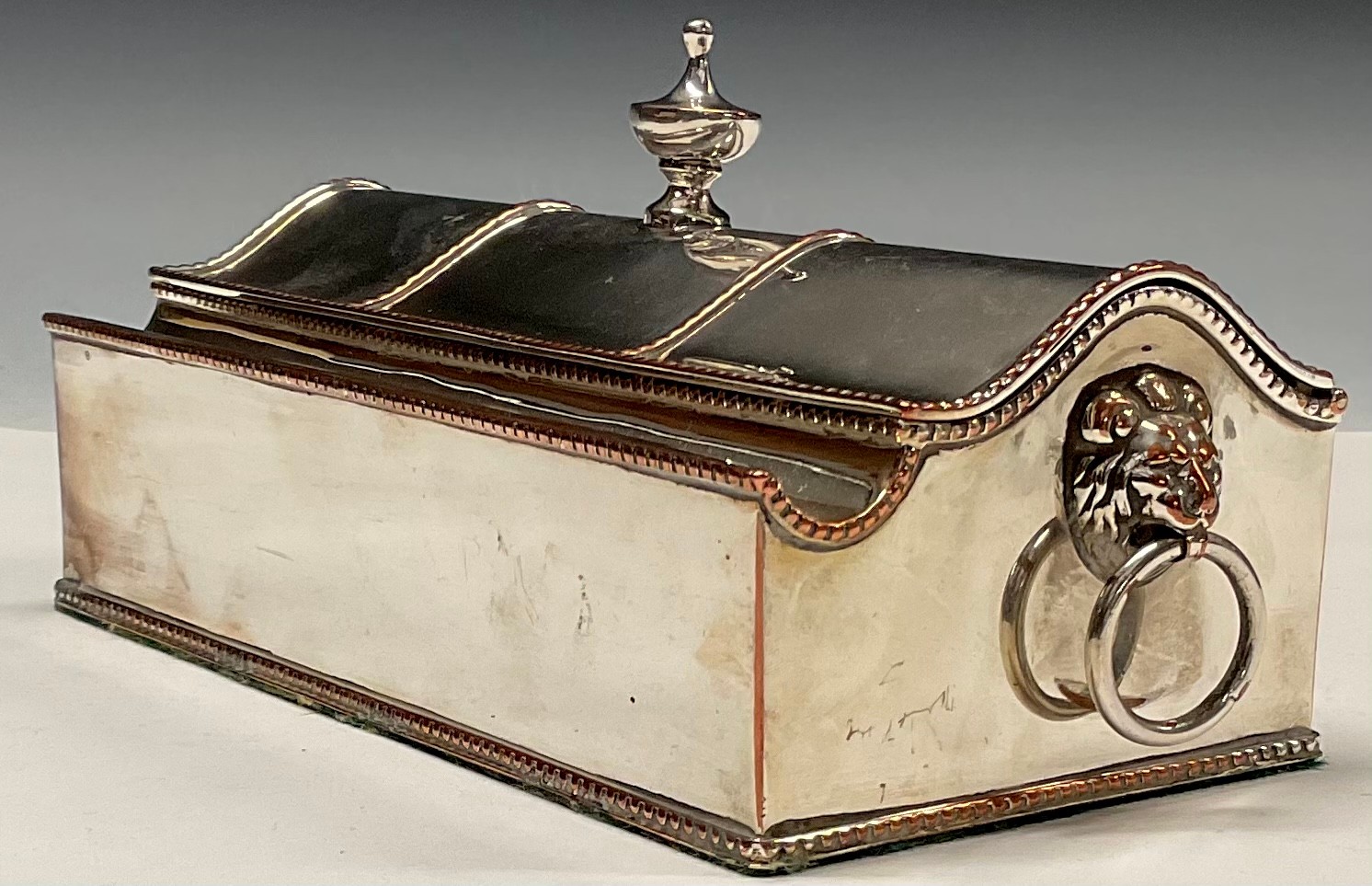 A George III Old Sheffield Plate treasury inkstand, hinged serpentine cover with urnular finial,