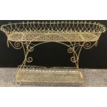 An early 20th century oval wirework plantstand, shaped under tier, 73cm high, 118cm long, 28cm wide