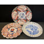 A 19th century Japanese imari shaped circular charger, 35cm diameter; another; blue and white plate,