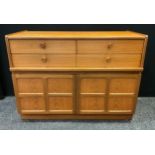 A Nathan teak squares sideboard, four short drawers over two cupboard doors, 75cm high, 102cm