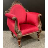 A Victorian carved mahogany arm chair, shaped and pierced cresting, carved scrolling arms, turned