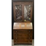 A set Jaycee oak linen fold bureau bookcase