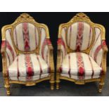 A pair of French Rocco style gilt wood armchairs, ornate frames, striped upholstery, NB - This