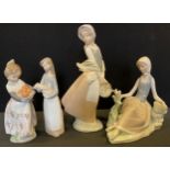 A Lladro lady, reclining with a bird, 17cm high, printed mark; others, girl wit ha piglet, 17.5cm