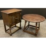 A low oak two door side cabinet, carved doors, c.1960; and oak circular coffee table (2)