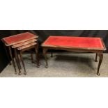 A leather topped mahogany coffee table; a similar nest of tables