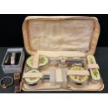 A mid 20th century vanity case, with chrome backed brushes and bottles, wristwatches, Limit,