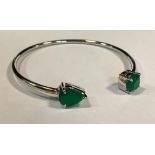 A silver open bracelet, set with pear and round green onyx, boxed