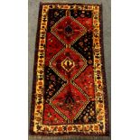 A Persian Lori 'Nomad' rug / carpet, hand-knotted in deep tones of red, indigo and black, 217cm x