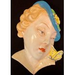 An Art Deco Royal Dux wall mask, of a lady with butterfly on her shoulder, impressed mark, 15514