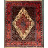 A Senneh rug / carpet, hand-knotted in tones of cream, deep red, and burgandy, 150cm x 125cm.