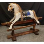 A mid 20th century dapple-grey painted rocking horse, stained pine base, 101cm tall (79cm to saddle)