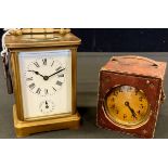 A brass carriage clock, Roman numerals, subsidiary seconds dial, 10cm high; a travel clock, in