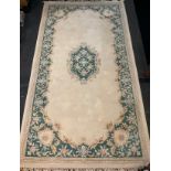 A Chinese woollen carpet, in beige and green, 200cm x 336cm