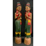 Tribal Art - a pair of large carved and painted Tibetan figures, of girls in traditional dress,