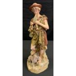 A large Royal Dux figure, of a shepherd, playing the pipes, a dog at his feet, 51cm high, pink