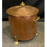 An Arts and Craft cylindrical copper fuel bin, brass urn finial three spade feet, 44cm high