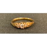A Victorian three stone diamond ring, old mine cut, 18ct gold shank, 2.2g