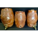 A 19th century stoneware Gin barrel, 26.5cm high; others relief decorated with lions, grape vines,