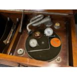 A Gilbert mechanical gramophone, walnut cabinet, along with a small quantity of 78 records.