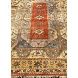 A Milas hand-knotted wool pile rug / carpet, woven with stylised regional motifs in muted shades