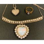 A diamond solitaire ring, illusion set, 18ct gold shank; a sterling silver heart locket; etc