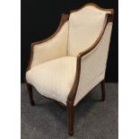 An Edwardian mahogany sitting room wing chair, serpentine back, boxwood stringing to arms and