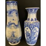 A contemporary Chinese blue and white vase, tapering body, decorated with dragons, cresting waves,