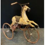 A Victorian style child`s tricycle Horse, with carved wooden horse, horsehair tail, on metal and