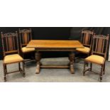 A mid 20th century oak refectory dining table and 4 chairs, rectangular top, carved frieze,