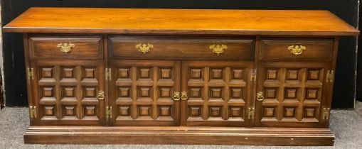 A 20th century oak sideboard, over-sailing rectangular top, above a row of two short and one long