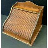 An early 20th century tambour front desk top stationery box, brass bound inlaid mahogany case,