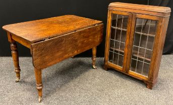 A Victorian oak kitchen table, with single drop-leaf, rounded rectangular top, turned legs,