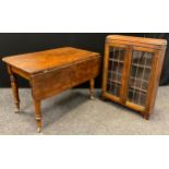 A Victorian oak kitchen table, with single drop-leaf, rounded rectangular top, turned legs,