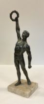 A mid 20th century bronzed spelter figure, 'Olympian Victor', mounted on a white marble base, 34cm
