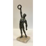 A mid 20th century bronzed spelter figure, 'Olympian Victor', mounted on a white marble base, 34cm