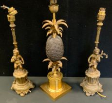 A Maison Charles style gilt and bronzed metal pineapple table lamp, 51cm high; a pair of cherub