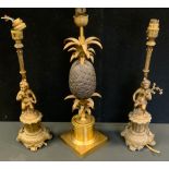 A Maison Charles style gilt and bronzed metal pineapple table lamp, 51cm high; a pair of cherub