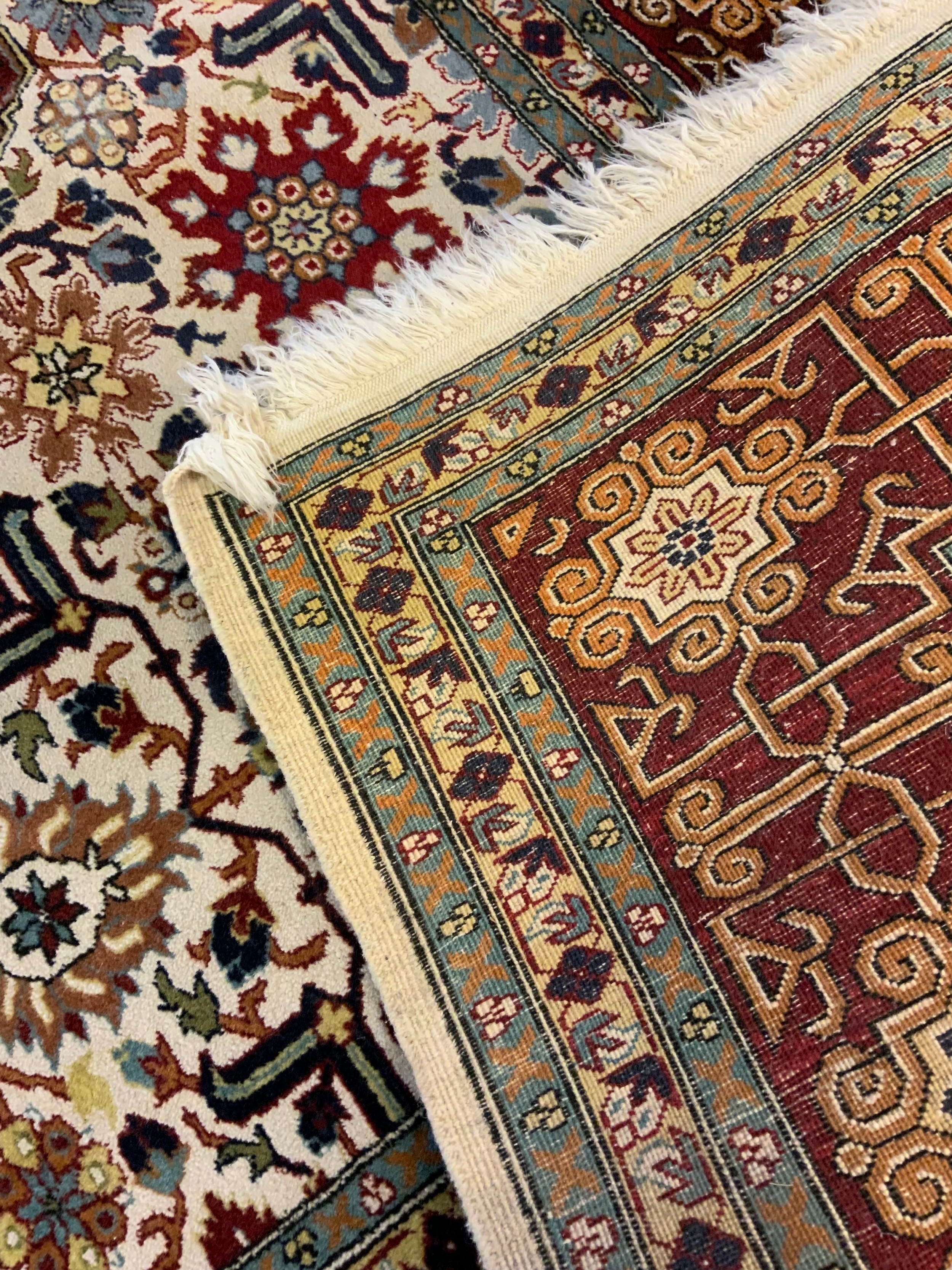 A Caucasian hand-made rug, large central field with stylised floral motifs in shades of red, - Image 2 of 2