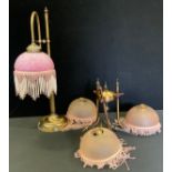 A bronzed metal table lamp, pink marble glass fringe shade, 54cm high; similar three branch