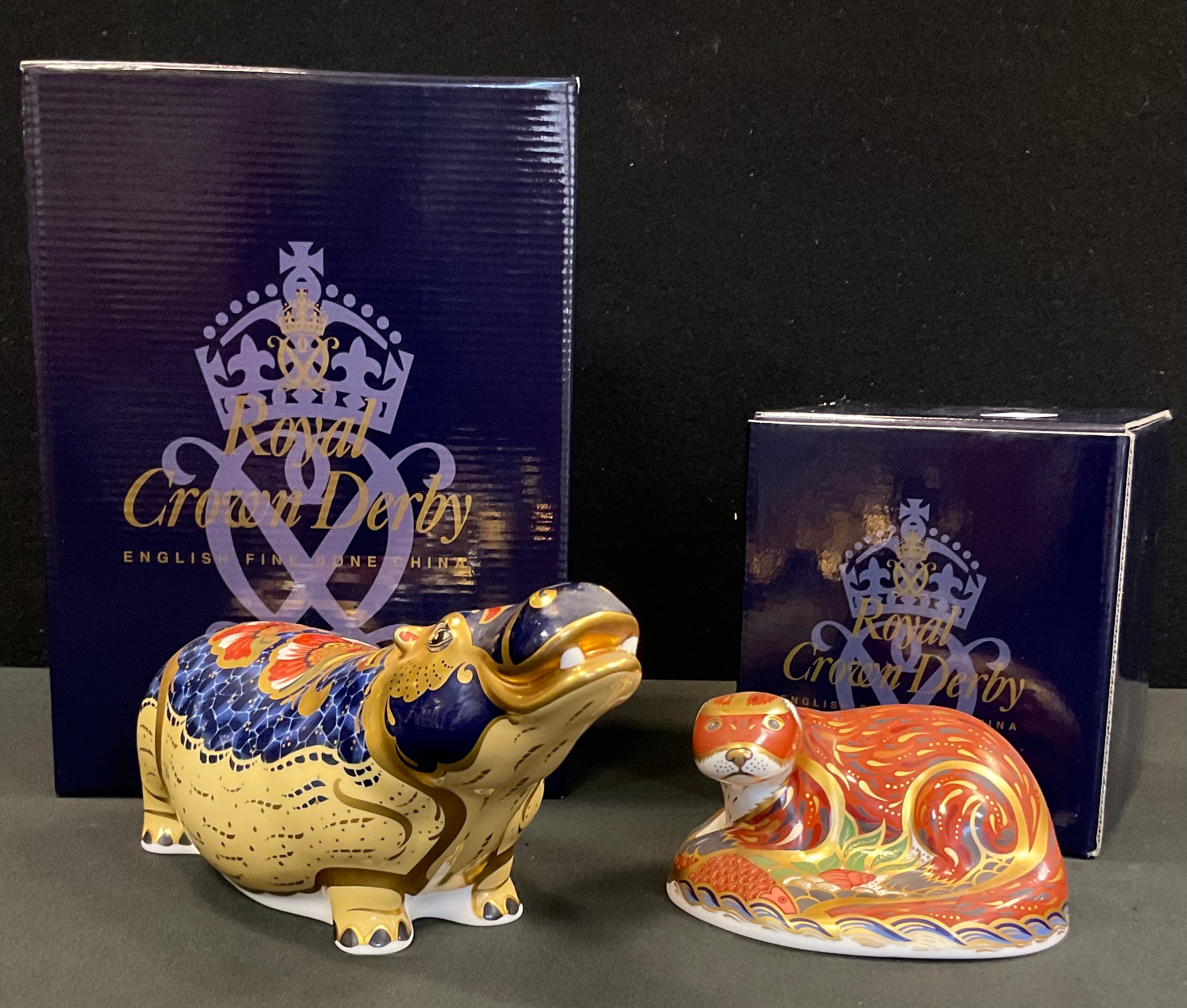 A Royal Crown Derby paperweight, Hippopotamus, silver stopper, printed mark, boxed; another Otter,