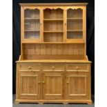 A Pine Kitchen Dresser, the top section having a pair of glazed doors enclosing two tiers of