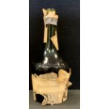 Wines & Spirits - an early 20th century bottle of DOM Benedictine, packing paper partial cover,